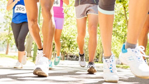 Peoples leg/feet moving as they participate in a marathon.
