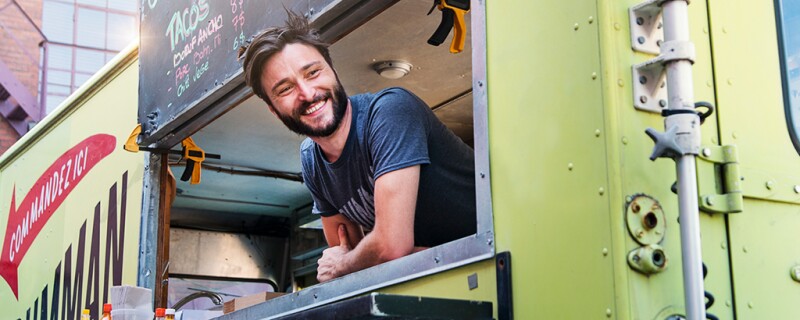 A worker working in a food truck. 