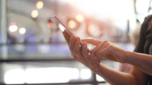 A person scrolling on their cellphone.