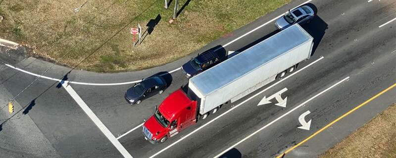 Birds eye view of an intersection with semi truck and cars