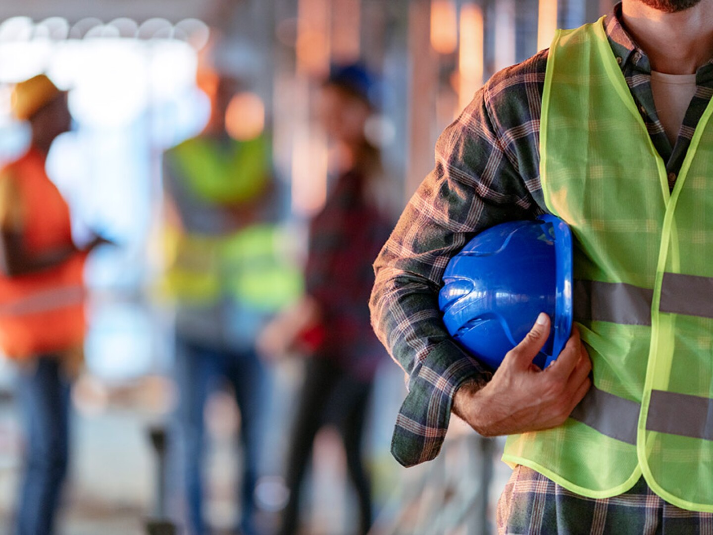 A man holding a helmet on the side of him.