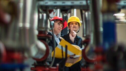 factory-workers-inspecting-equipment