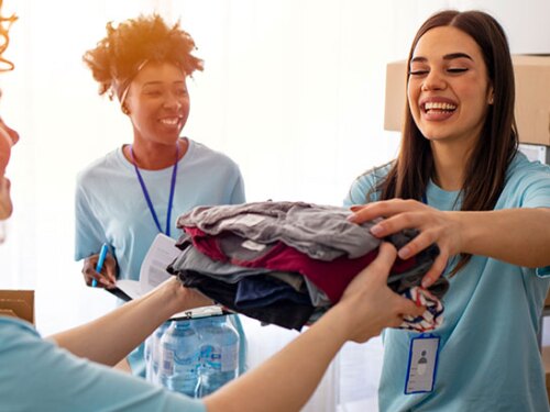 Photo of volunteers handing out clothes.