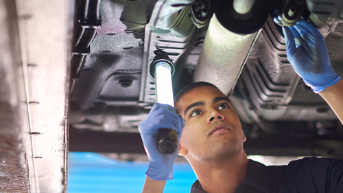 Mechanic inspecting a car exhaust