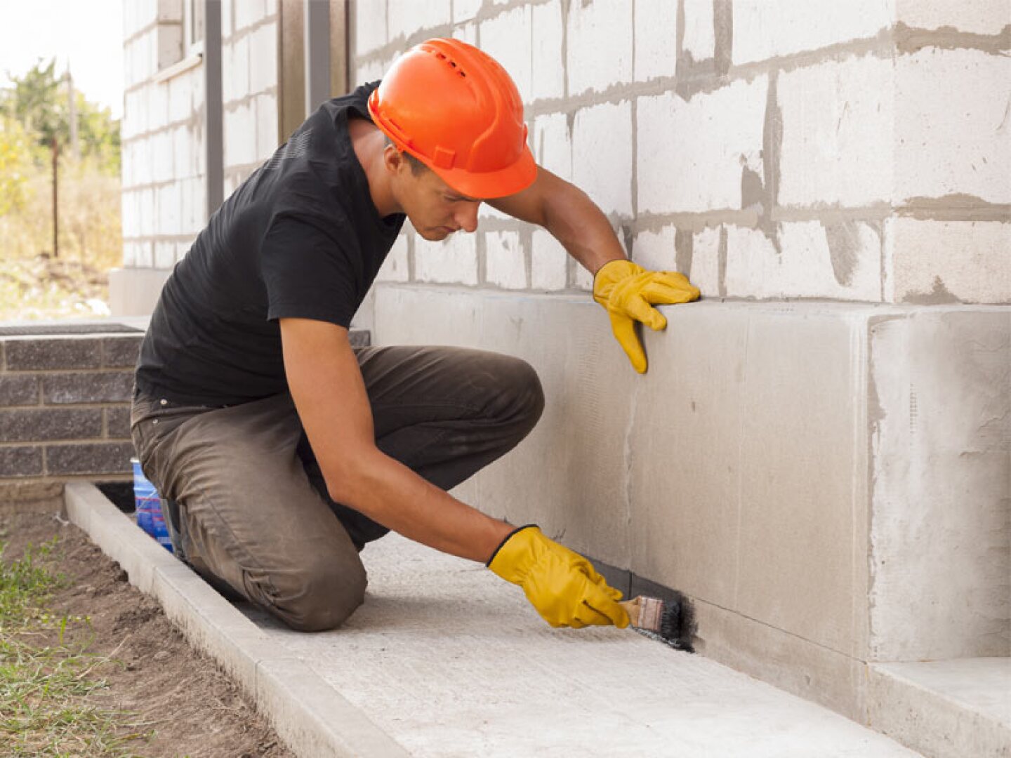 concrete worker finishing foundational wall