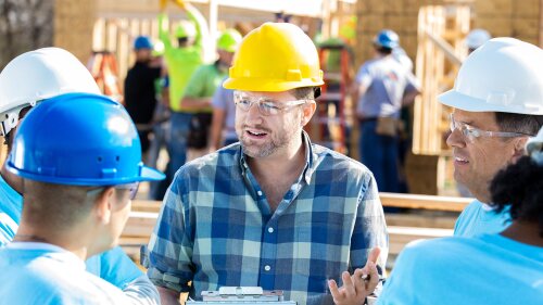 construction manager conversing his with construction team