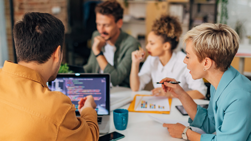 Employees talking around a table.