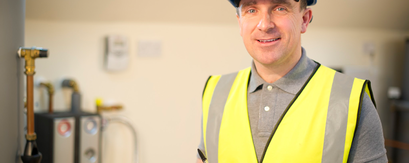 A man in a hard hat and yellow vest.