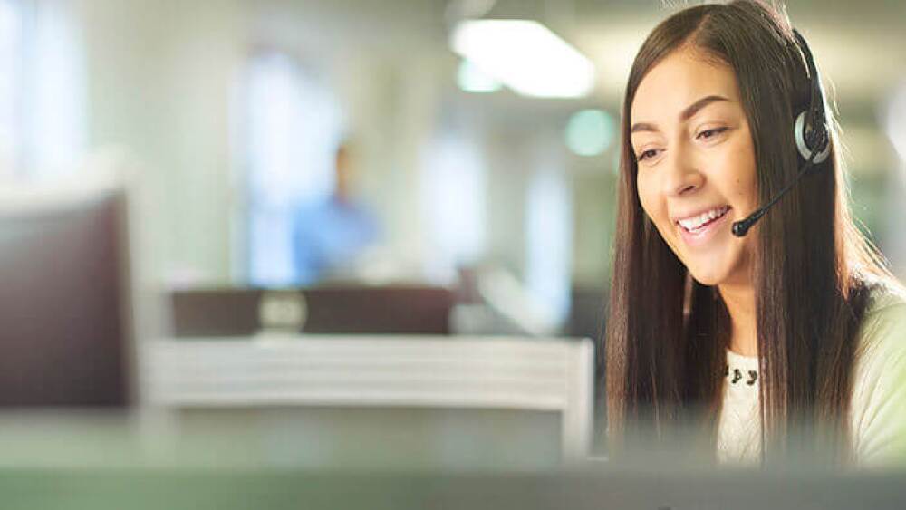 A customer service representative talking to someone on the phone.