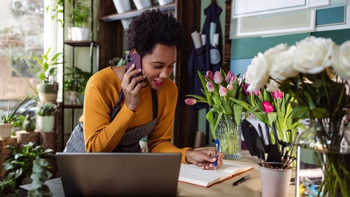 business woman making payment over the phone