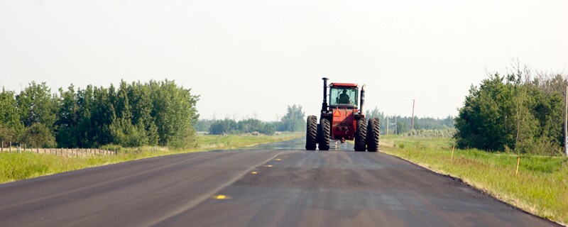 Tractor driving down the road.