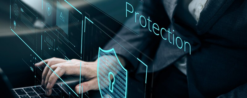 Someone typing on a laptop, over the picture it says "protection"