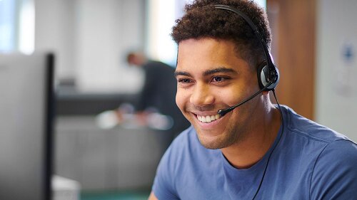 Customer service representative helping a customer on the phone.