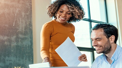 Female showing a male something on a piece of paper.
