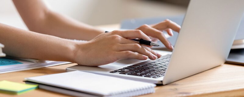 A person typing on a laptop. 