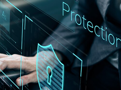 Someone typing on a laptop, over the picture it says "protection"