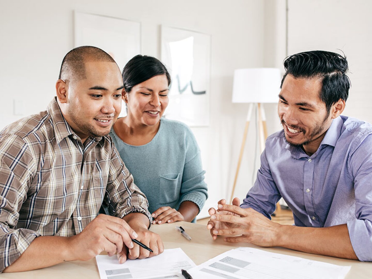 an insurance agent working with couple to review the insurance policy coverages.