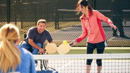 amateur pickleball players enjoying a game on a sunny day