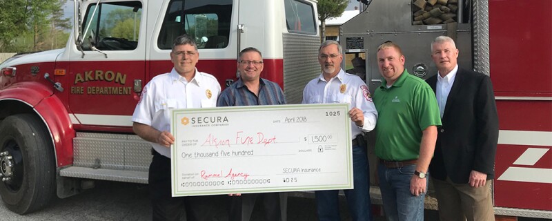 SECURA donating money to Akron fire department.