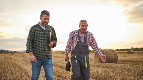 A farmer walking with an independent agent
