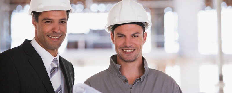 two commercial general contractors with hard hats on 