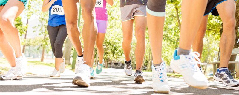 Peoples leg/feet moving as they participate in a marathon. 