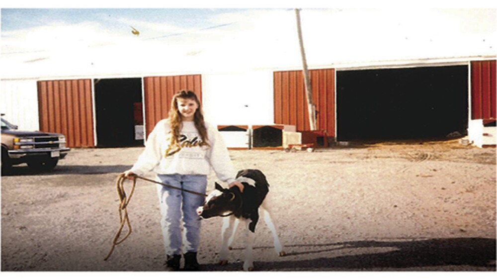 jenny with a calf at her families farm.