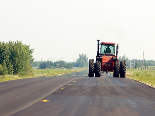 Tractor driving down the road.