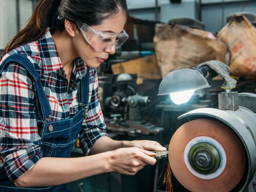 woman using a metal grinding wheel